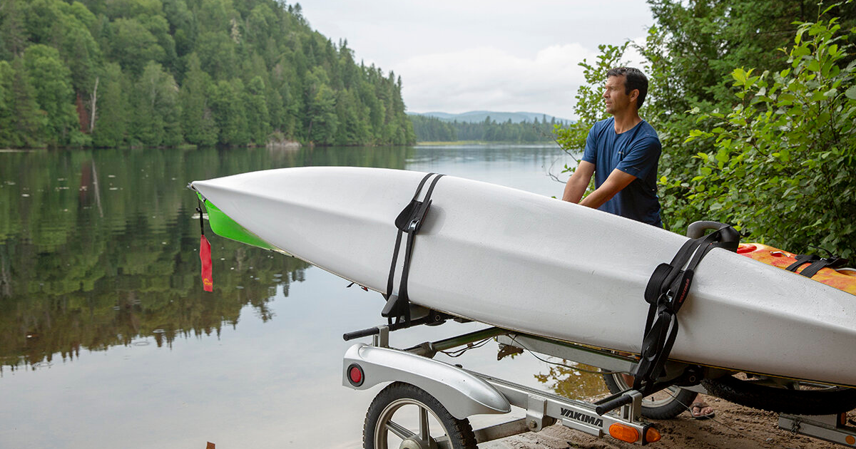 transporting your kayak and what to consider when storing it ken whiting using a kayak in front of the water