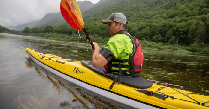 ken whiting kayaking with an nrs dry top aquabound paddle and nrs pdf in the water in quebec