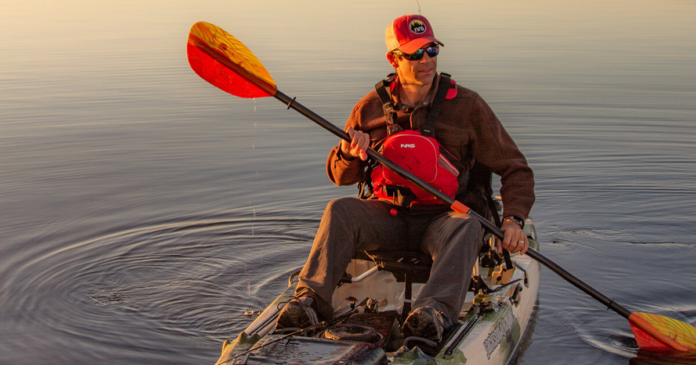 ken whiting using a sit on top kayak with an aquabound paddle on the water kayaking