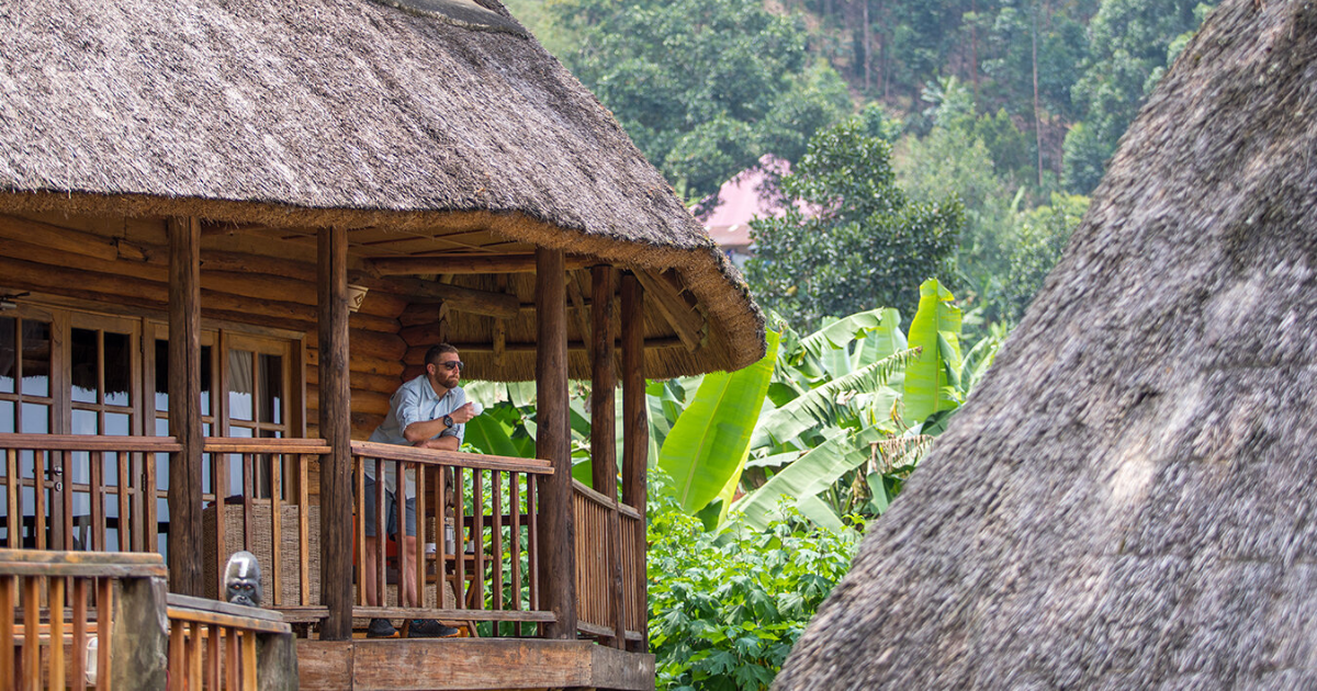 eric hanson looking out a villa in uganda on a backpacking and hiking trip