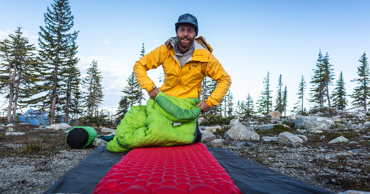 eric hanson laying out his sleep system for backpacking and hiking in revelstoke british columbia backpacking for beginners