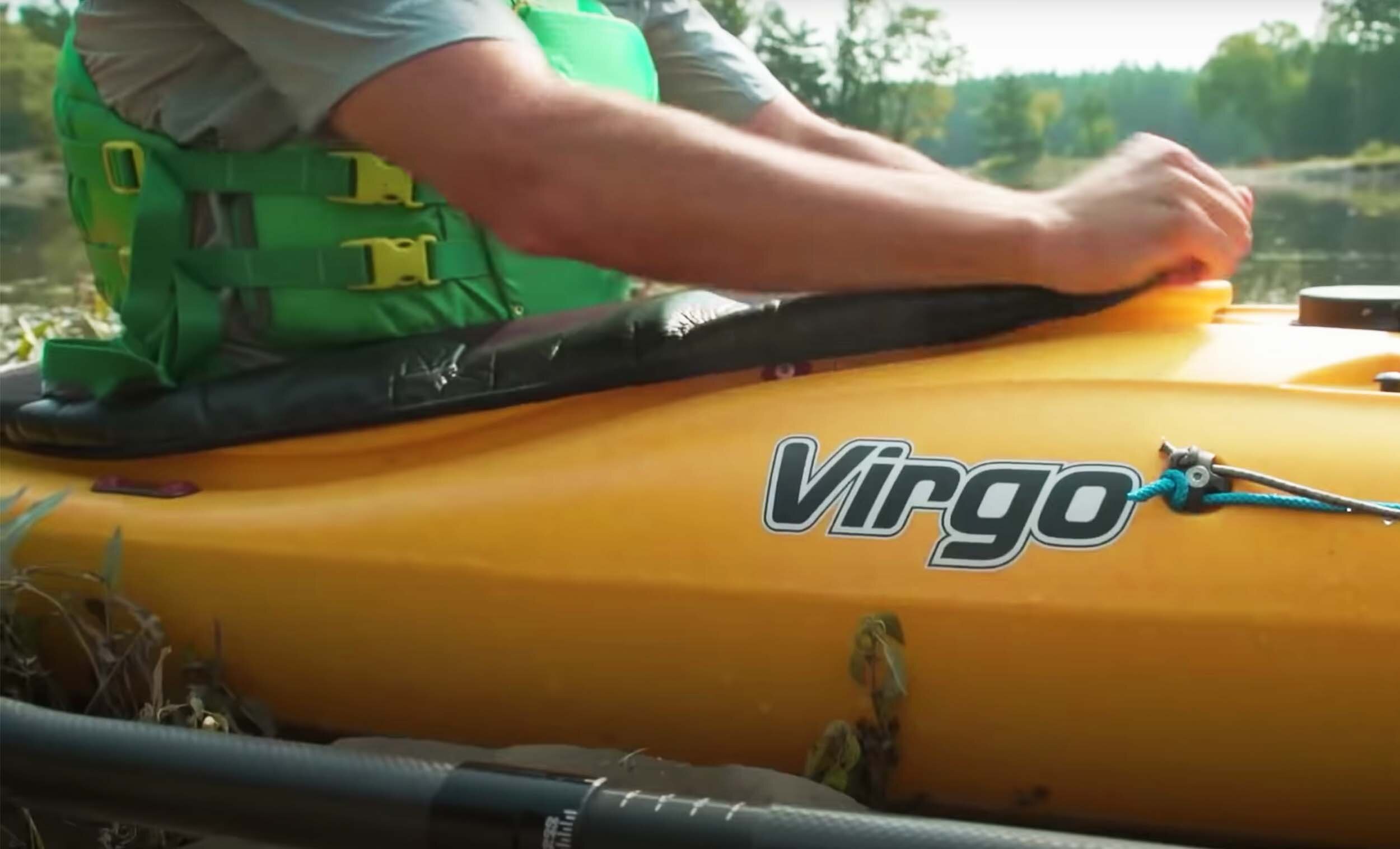close up of the pandh virgo logo on a white kayak ken whiting paddletv and the kokatat pfd life jacket