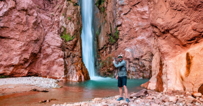eric hanson in front of a waterfall backpacking and hiking deer creek