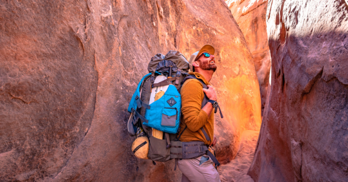 most underrated pieces of backpacking gear featured image eric hanson backpacking in lake powell