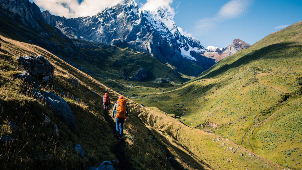 how to go on an international trek two backpackers climbing a high mountain in peru