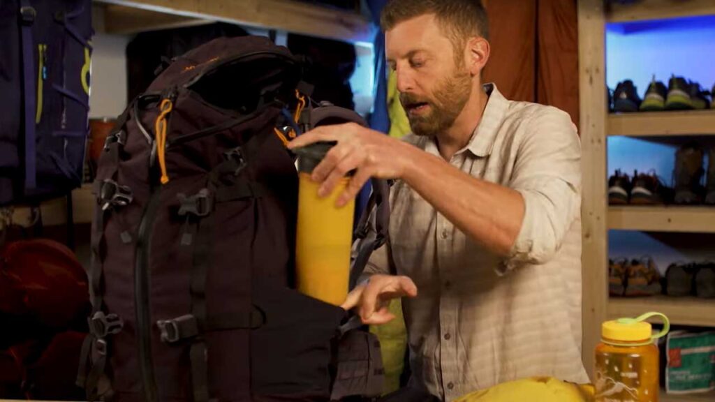backpacking packing list tip: water bottles, hiking poles and more need to be secured to the sides of your backpack