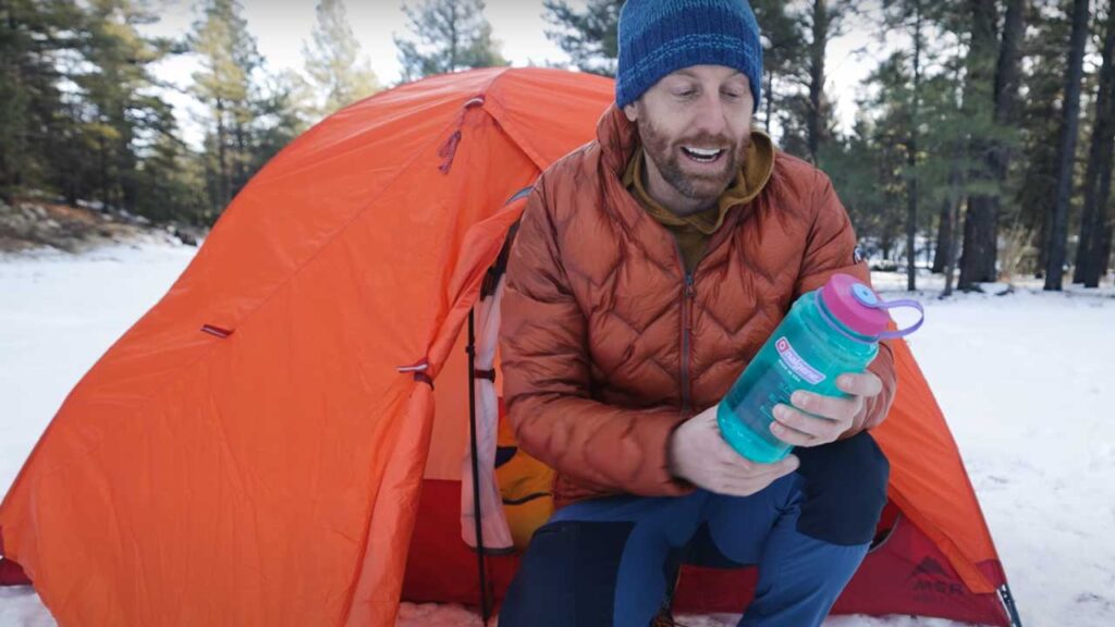 winter backpacking mistakes: A water bottle in your sleeping bag gives you water all night