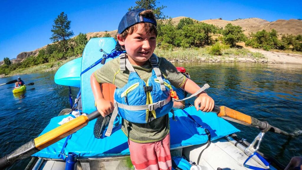 best family adventure vacations: Everyone gets a chance to be the raft guide on our trips!