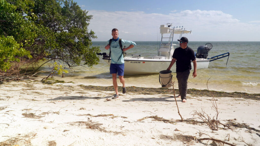 Chef Corso and Captain Chris walking up a beach after disembarking from the fishing boat.