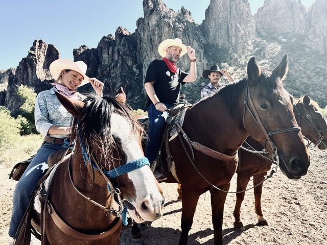 Jonathan Thompson, and 2 guides each on a horse tipping their stetson style hat, Scottsdale, Arizona