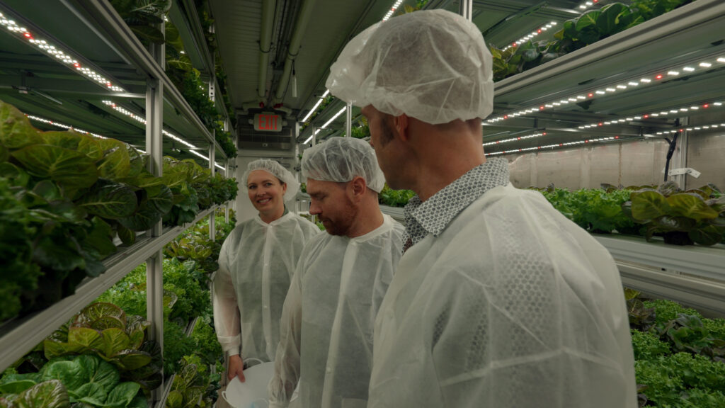 Chef Corso and guests exploring the interior of container ship farm.