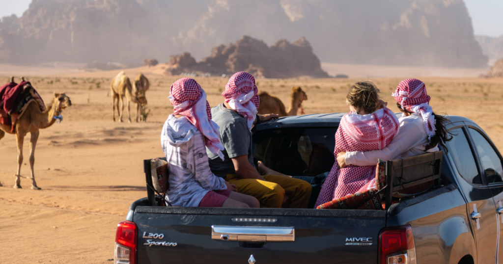 nick troutman, emily jackson, and family riding in a jeep in wadi rum jordan on an adventure