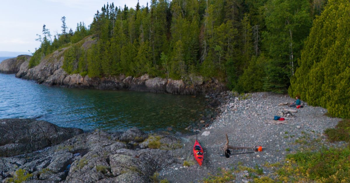 Ken Whiting enjoying a cup of coffee at his campsite overlooking Lake Superior, capturing the peaceful start to a day.