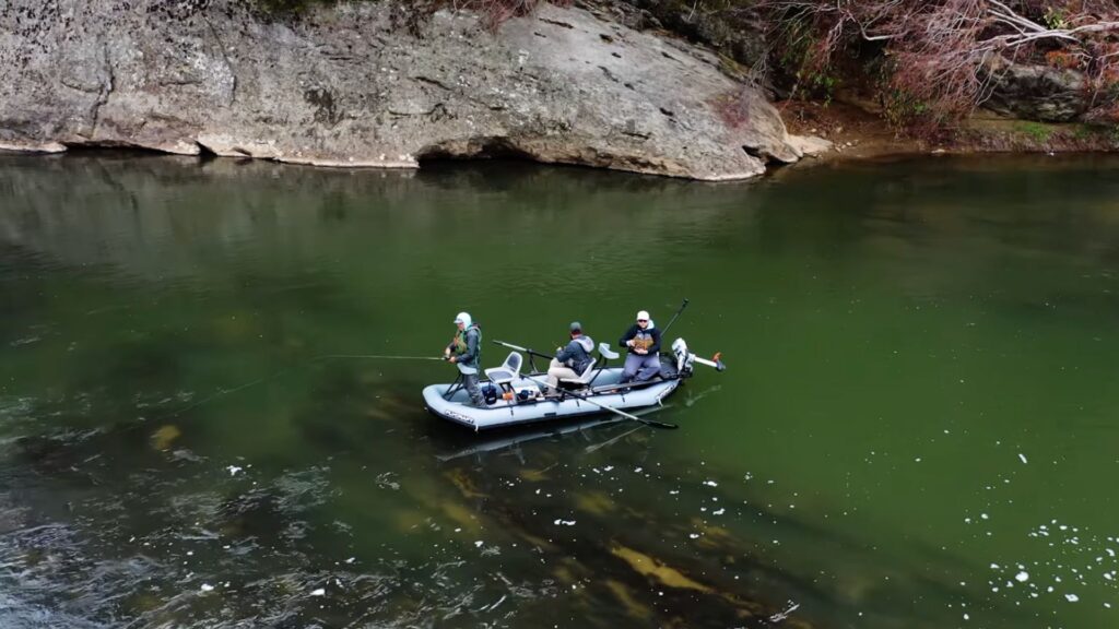 drone shot of three men in flycraft guide 3 person inflatable boat