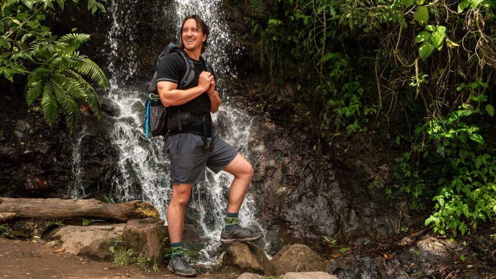 Travel Accident Insurance provided by Redpoint, Mike in front of waterfall in Costa Rica