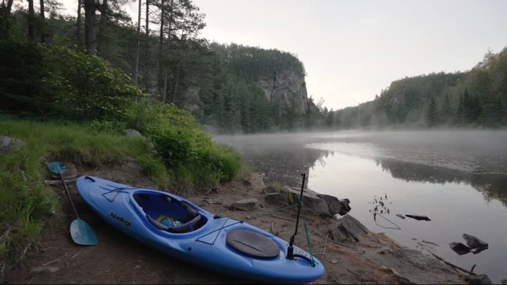 kayak camping trip, pulling up kayak from water