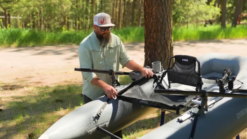 Jameson adjusting net mount on NRS Oxbow fishing raft