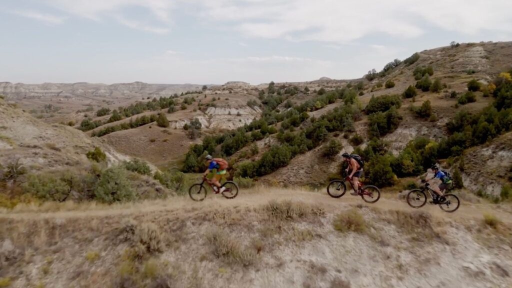 Group of cyclists mountain bike riding on the Maah Daah Hey Trail in North Dakota